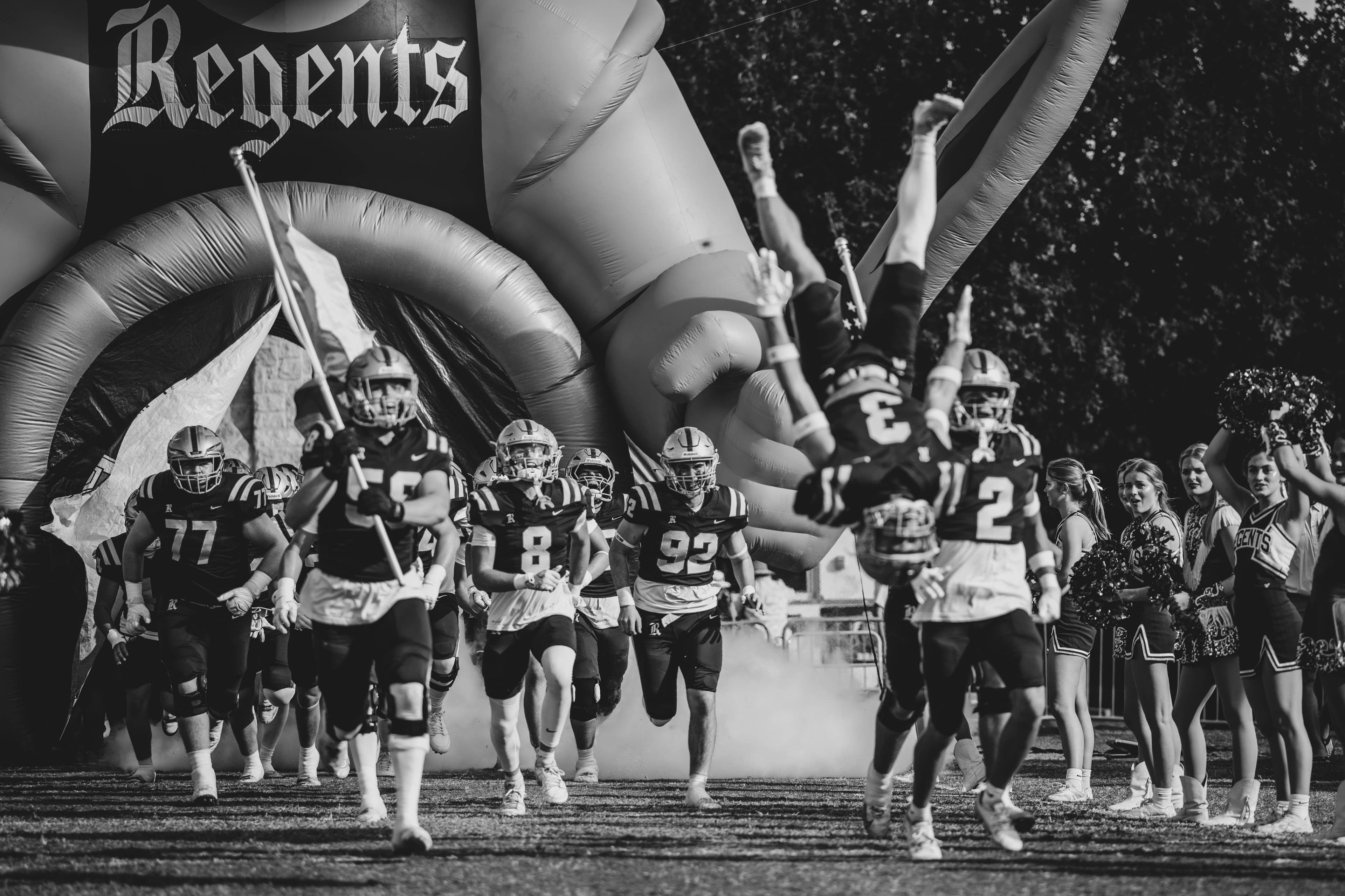 Regents team charging onto the field through the tunnel