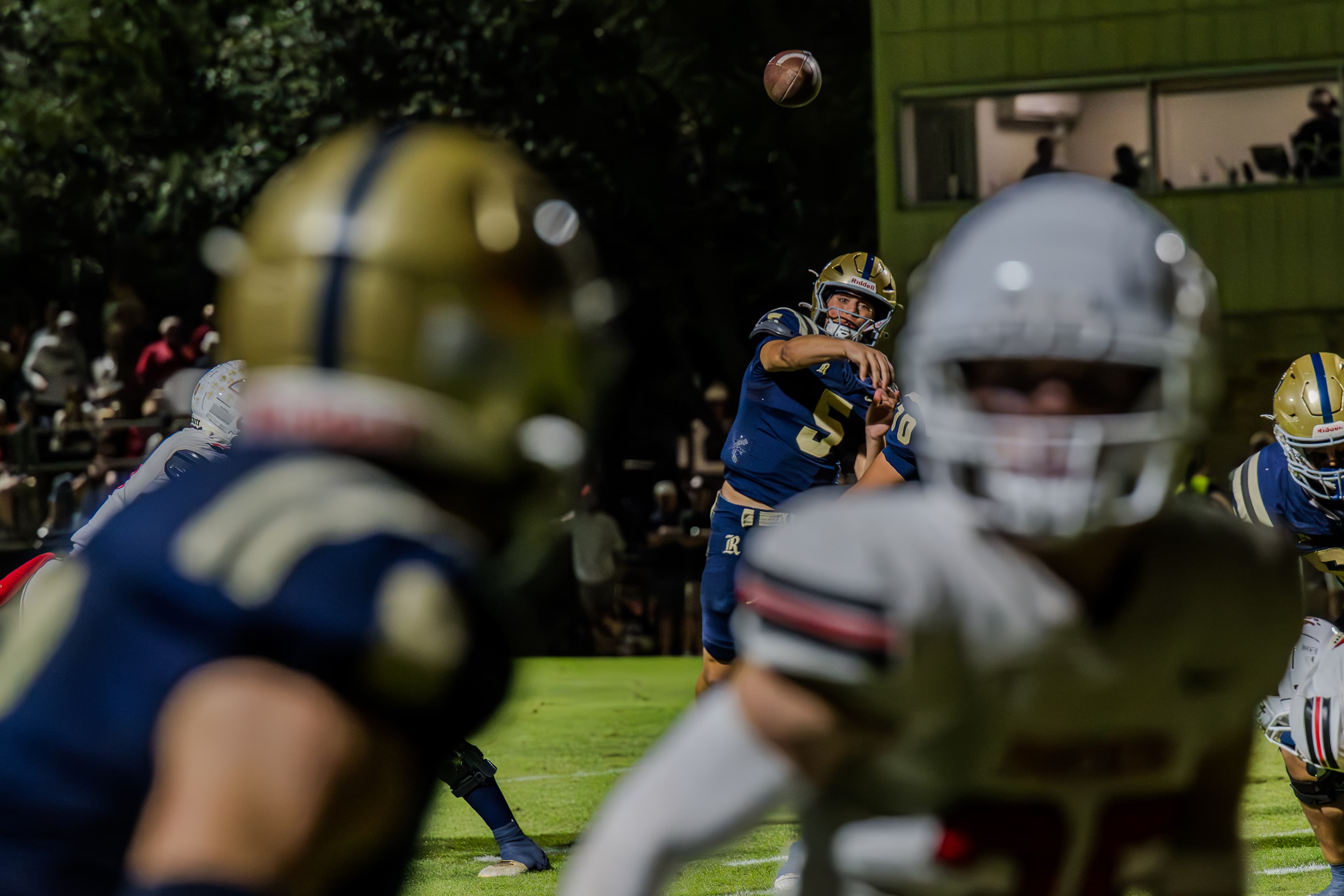 Quarterback releasing a pass through traffic on a Friday night