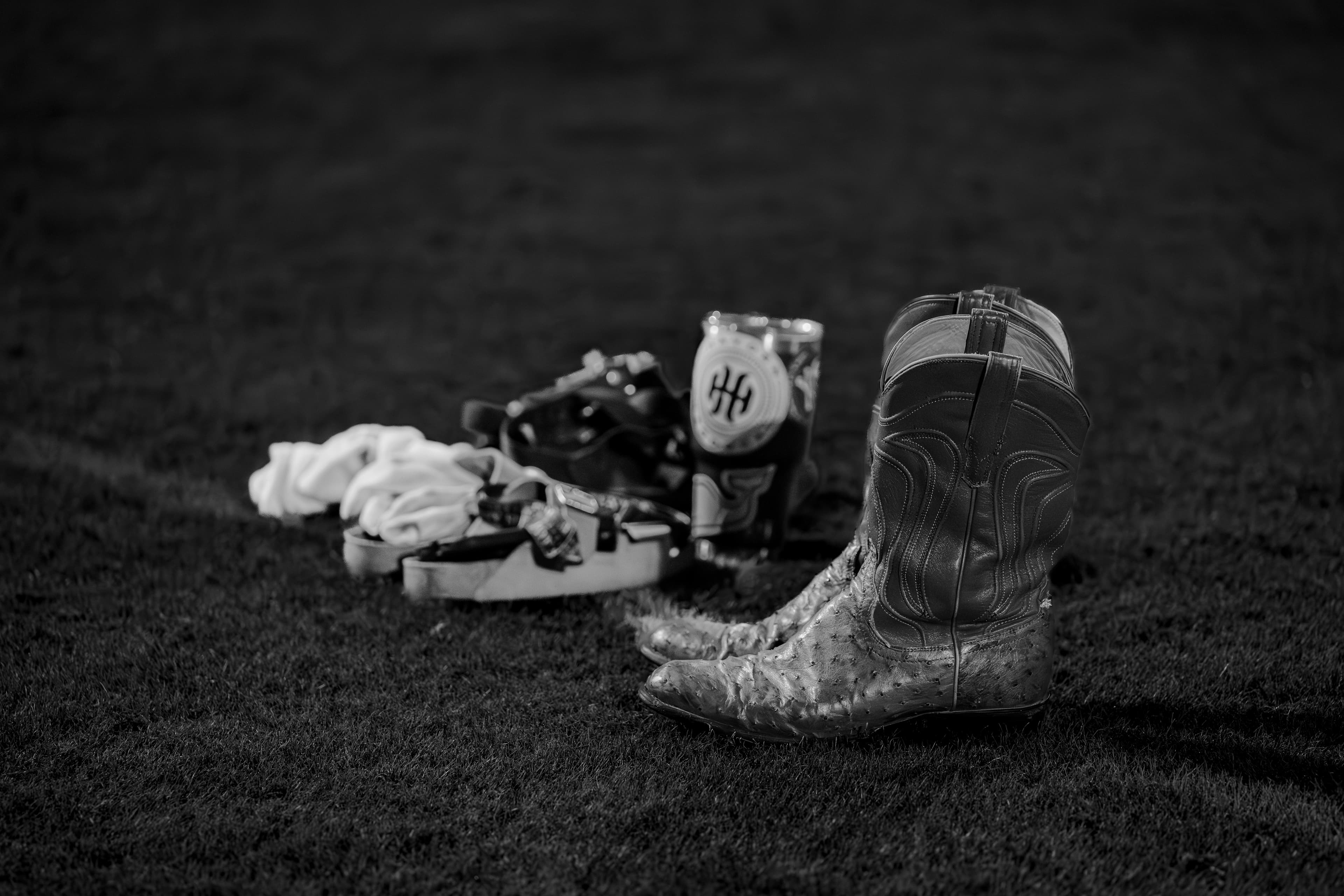 Cowboy boots alongside football cleats on the field — Texas high school football